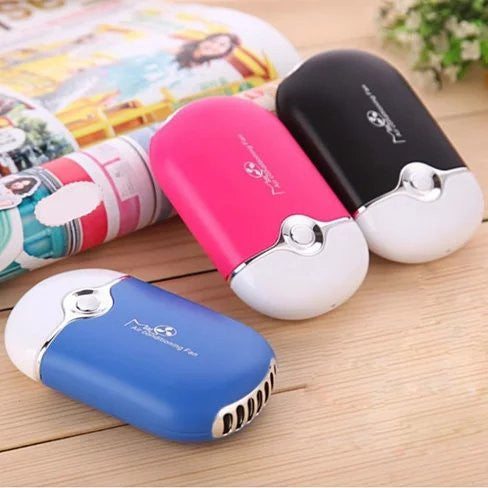 Porta Cooler Portable Air Conditioning USB powered personal mini fan on desk with green charging indicator